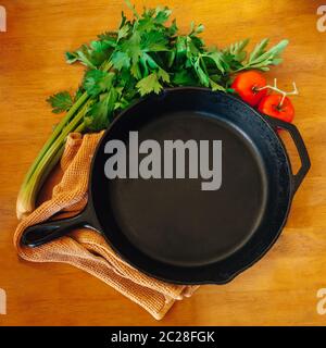 Cast iron pan and tomatoes and cilantro Stock Photo