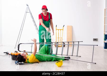 Injured worker and his workmate Stock Photo