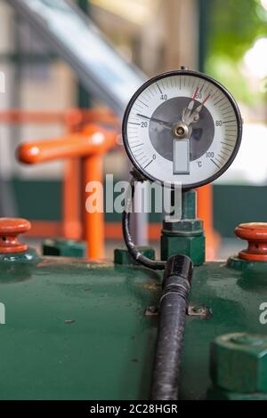 Measuring instrument on a historic generator in an old power plant Stock Photo
