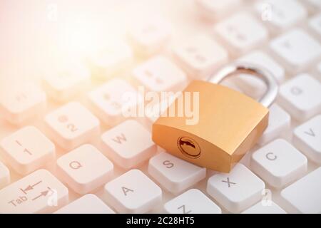 Security concept with metal padlock on computer keyboard Stock Photo