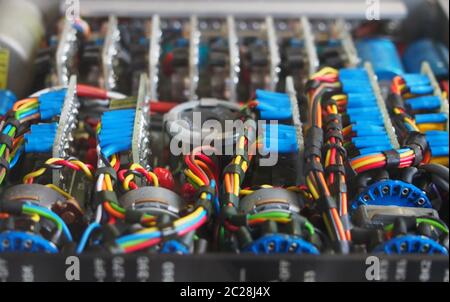 selective focus image of complex colored wiring and connectors joining circuit boards with electrical components Stock Photo