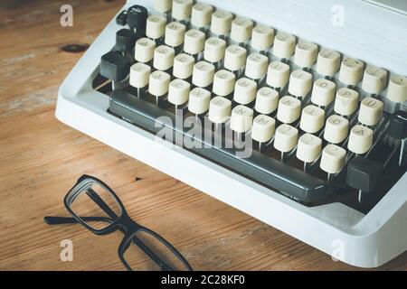 Old fashioned vintage typewriter on wood desk Stock Photo