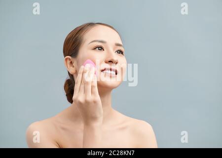 young beautiful woman applying her make-up Stock Photo