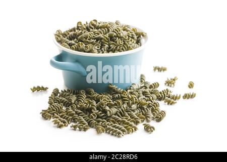 Uncooked colorful pasta with spinach flavor isolated on white bakground. Stock Photo