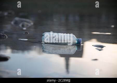 Environmental pollution: plastic bottle on the beach Stock Photo
