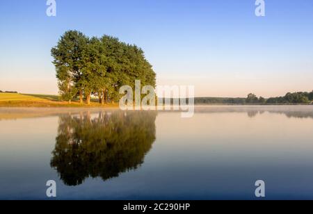 Colorful sunrise on a small lake near the village Stock Photo