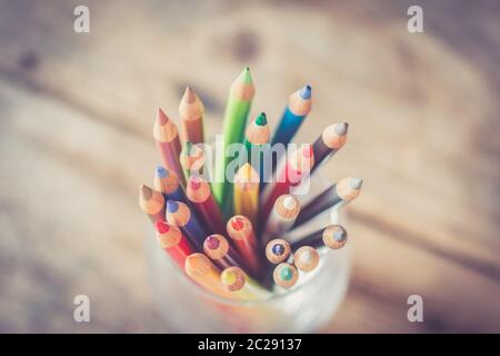Creativity: Colored pencils in a can on rustic wooden table Stock Photo