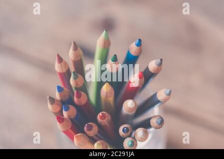 Creativity: Colored pencils in a can on rustic wooden table Stock Photo