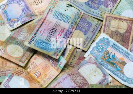 selective focus of vintage/old Indian currency rupees hundred,fifty,ten,five,tow and one notes arranged in random manner. Stock Photo