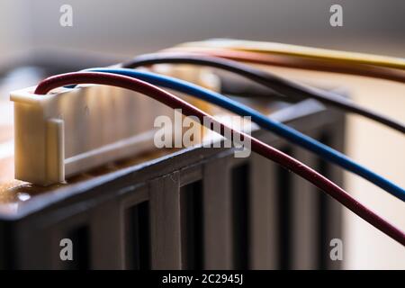 Colored power cables that come from a transformer Stock Photo