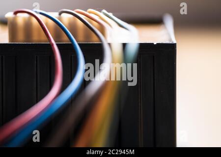 Colored power cables that come from a transformer Stock Photo