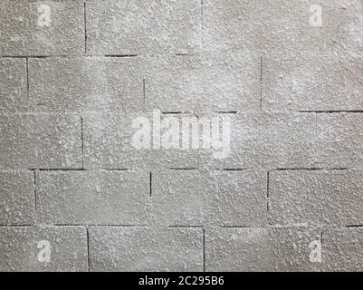 Old grey stone masonry wall texture made of foam blocks or airblocks. Abstract surface plastered. Grunge, weathered construction structure. Stock Photo