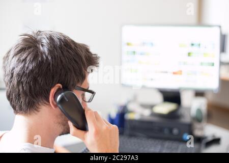 Employee is talking on the phone with customers Stock Photo