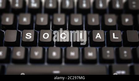 Social media concept. Social word written on keypad. Black keys with white letters message for global digital communication on pc keyboard. Blur butto Stock Photo