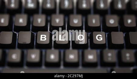Blog word written on keypad. Black keys with white letters message on pc keyboard. Blur buttons background. Telecommunication concept. Stock Photo