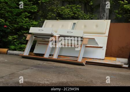Selective focus of abandoned drawers thrown away at curbside near garbage room waiting for recycling process, climate change concept Stock Photo