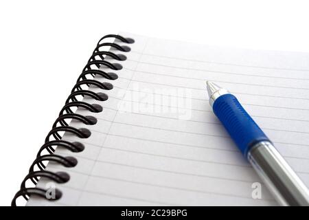 Notepad and pen on a isolated white background at an angle with medium depth of field Stock Photo
