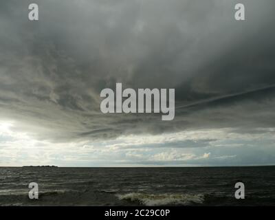 huge low dark clouds approaching the shore from the sea Stock Photo