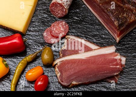 south tyrolean speck on slate Stock Photo