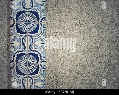 Close up shot of a wall decorated with tiles of various models. Stock Photo