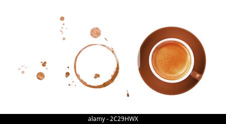 Brown cup full of espresso coffee on saucer, with ring coffee stains and drops isolated on white background, elevated top view, directly above Stock Photo