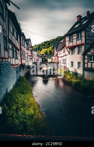 Monreal in the Eifel in Germany. A small half-timbered village directly on a river with a beautiful stone bridge