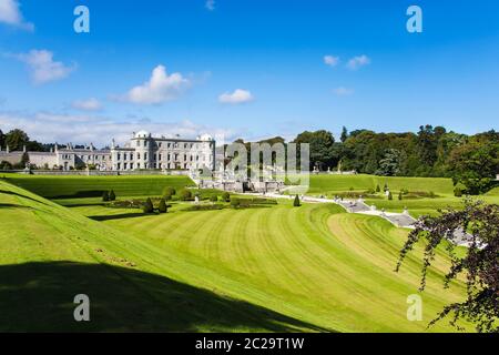 Tourists visiting Powerscourt Gardens one of the most beautiful gardens in Ireland view on mansion from terraced lawn Stock Photo