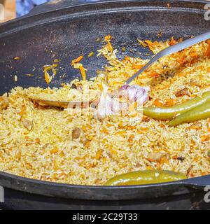 Traditional delicious pilaf with vegetables in a cauldron Stock Photo