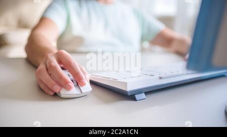 the developer works at computer, uses the mouse Stock Photo