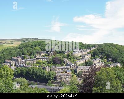 a scenic aerial view of the town of hebden bridge in west yorkshire with streets of stone houses and roads between woodland tree Stock Photo