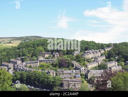 a scenic aerial view of the town of hebden bridge in west yorkshire with streets of stone houses and roads between trees and a b Stock Photo