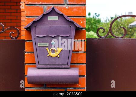 A beautiful mailbox hangs waiting for newspapers, parcels and letters from friends. Stock Photo