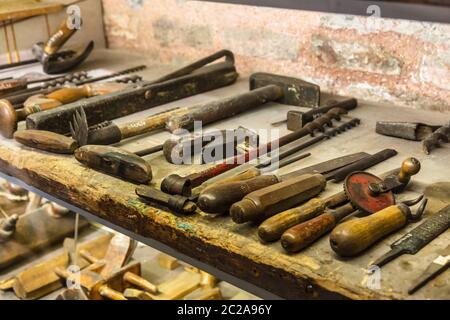 Collection of vintage woodworking tools on a rough workbench and blank copy space: carpentry Stock Photo