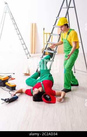 Injured worker and his workmate Stock Photo