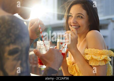 Couple in love drinking summer refreshing lemonade with rasberry on a balcony Stock Photo