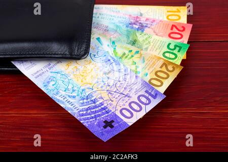 New Swiss Francs in the black wallet Stock Photo