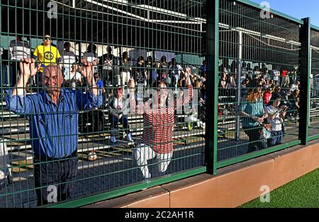 Parents following and supporting, a kids soccer match on tribune, in Milan. Stock Photo