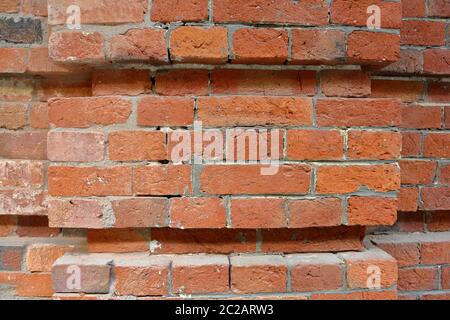 Embossed textured surface of the old orange brick and cement wall Stock Photo