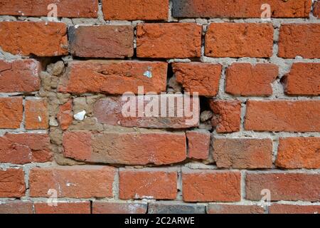 Embossed textured surface of the old orange brick and cement wall Stock Photo
