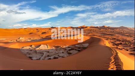 beautiful sunrise wide landscape, hidden Dead Vlei in Namib desert, view from top of dune with blue sky, Namibia, Africa wilderness landscape Stock Photo