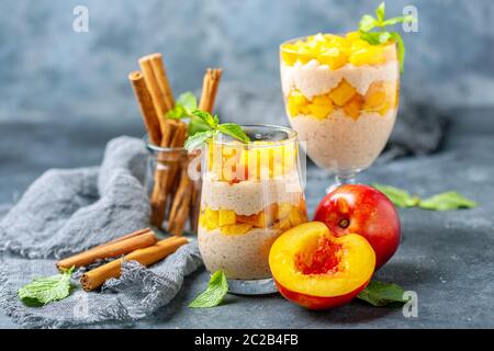 Rice pudding with pieces of nectarine in glasses. Stock Photo