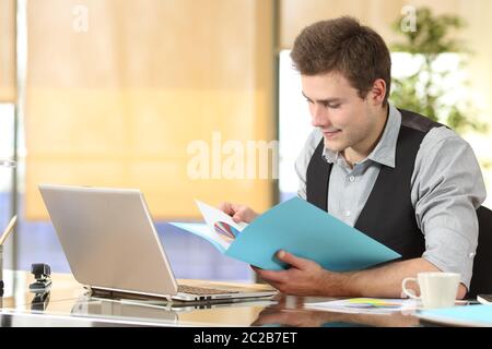 Serious businessman checking informs sitting at office Stock Photo