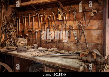 Complete workbench with a wall of tools in a workshop. Vintage look Stock Photo