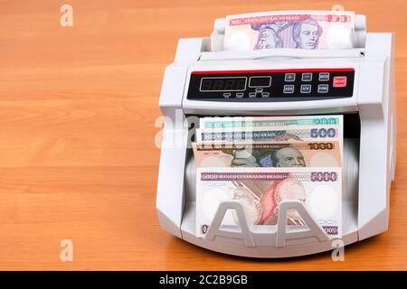 Old Brazilian money in a counting machine Stock Photo