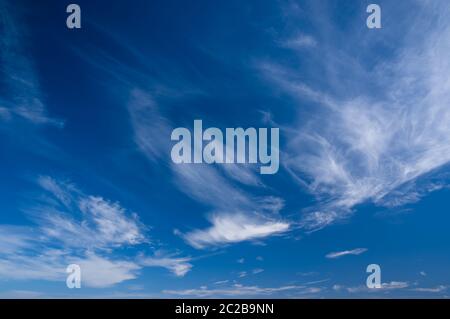 Blue skies with some high level cirrus clouds on a fine day. Stock Photo