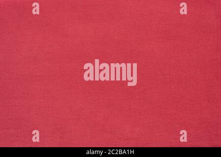Pink denim textured background. Cotton fabric dyed pink. Backdrop Stock Photo