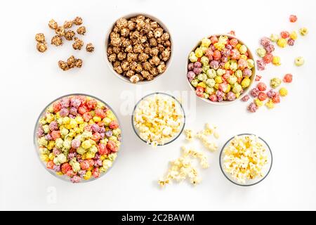 Flavored popcorn on white table top view Stock Photo