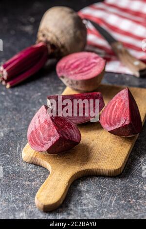 Tasty raw beetroot. Sliced beetroot on cutting board. Stock Photo