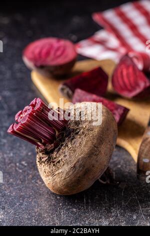 Tasty raw beetroot on old kitchen table. Stock Photo