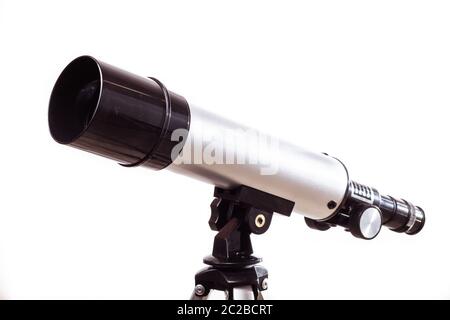 telescope on a white background laid on a rough wooden board Stock Photo